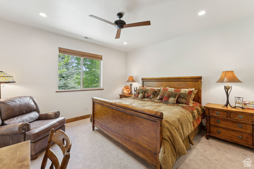 Bedroom with light colored carpet, recessed lighting, baseboards, and a ceiling fan