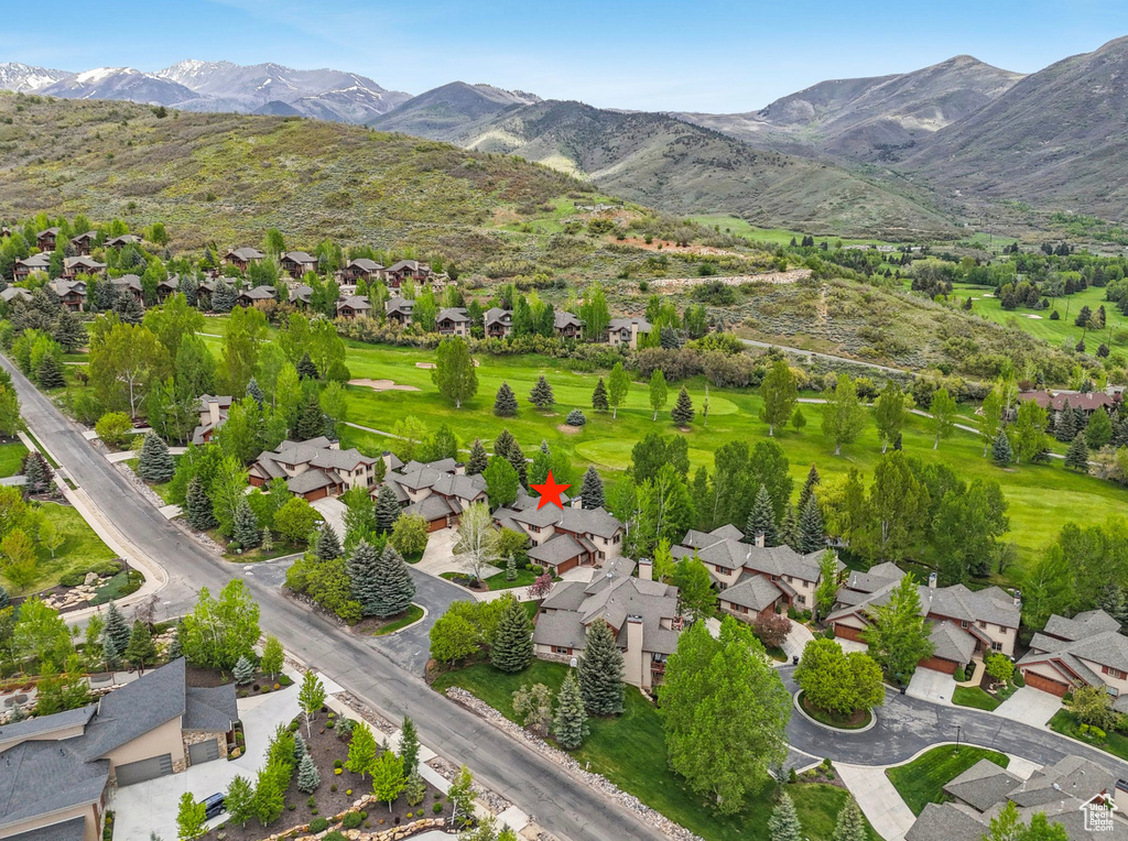 Aerial view of property\'s location with a mountainous background and nearby suburban area