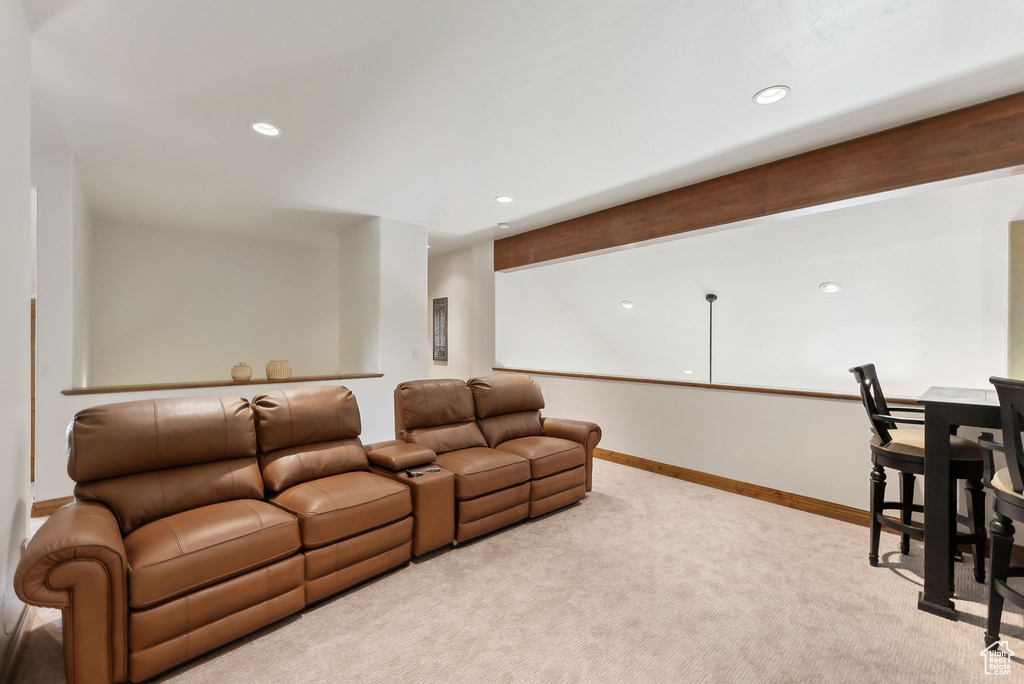 Carpeted living room with recessed lighting and baseboards