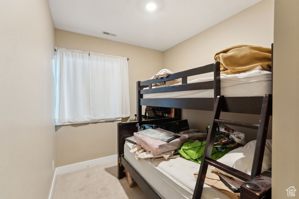 Carpeted bedroom featuring baseboards