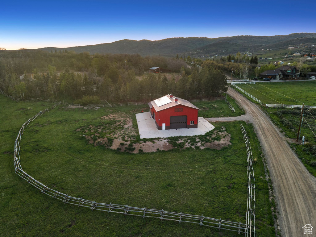 Aerial view of property and surrounding area with a mountain backdrop and rural landscape