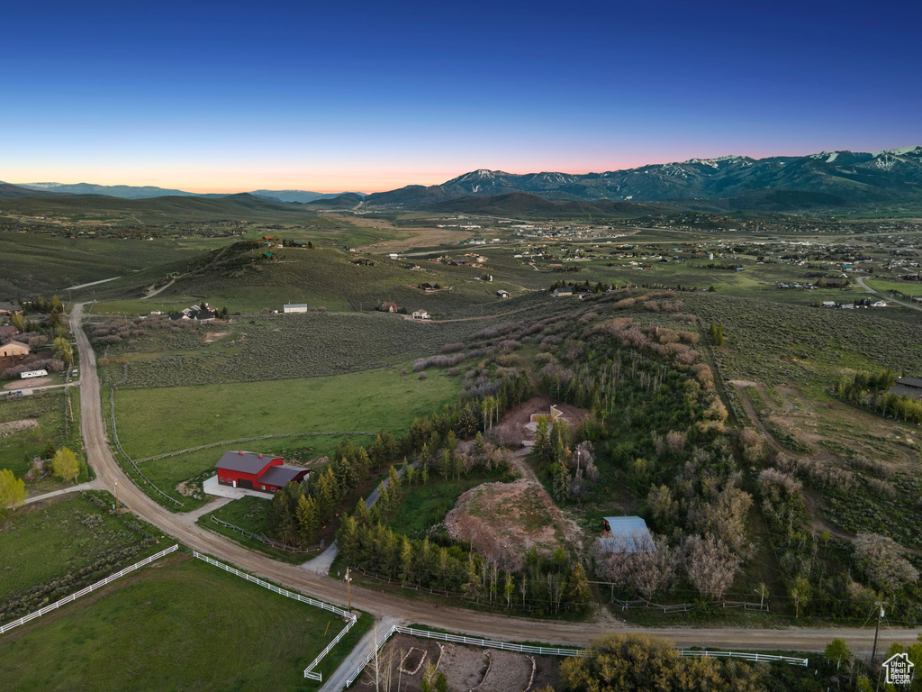 Aerial view at dusk of a mountain view and a view of rural / pastoral area