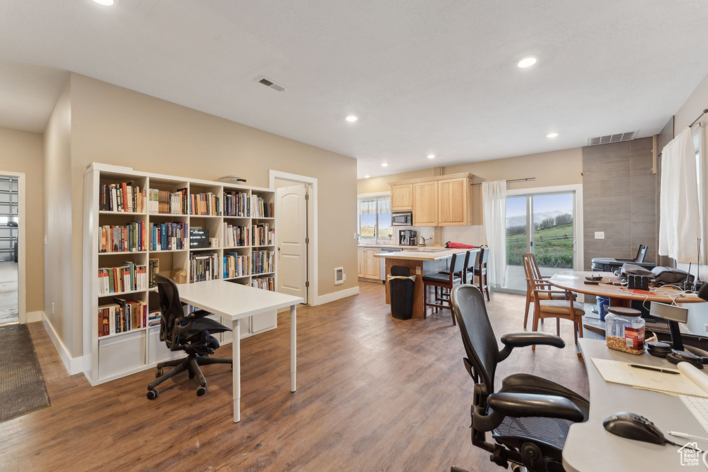 Home office featuring baseboards, wood finished floors, recessed lighting, and plenty of natural light