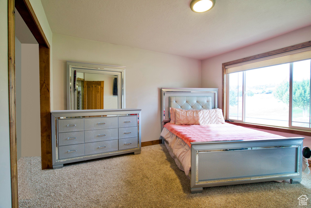 Bedroom featuring light carpet