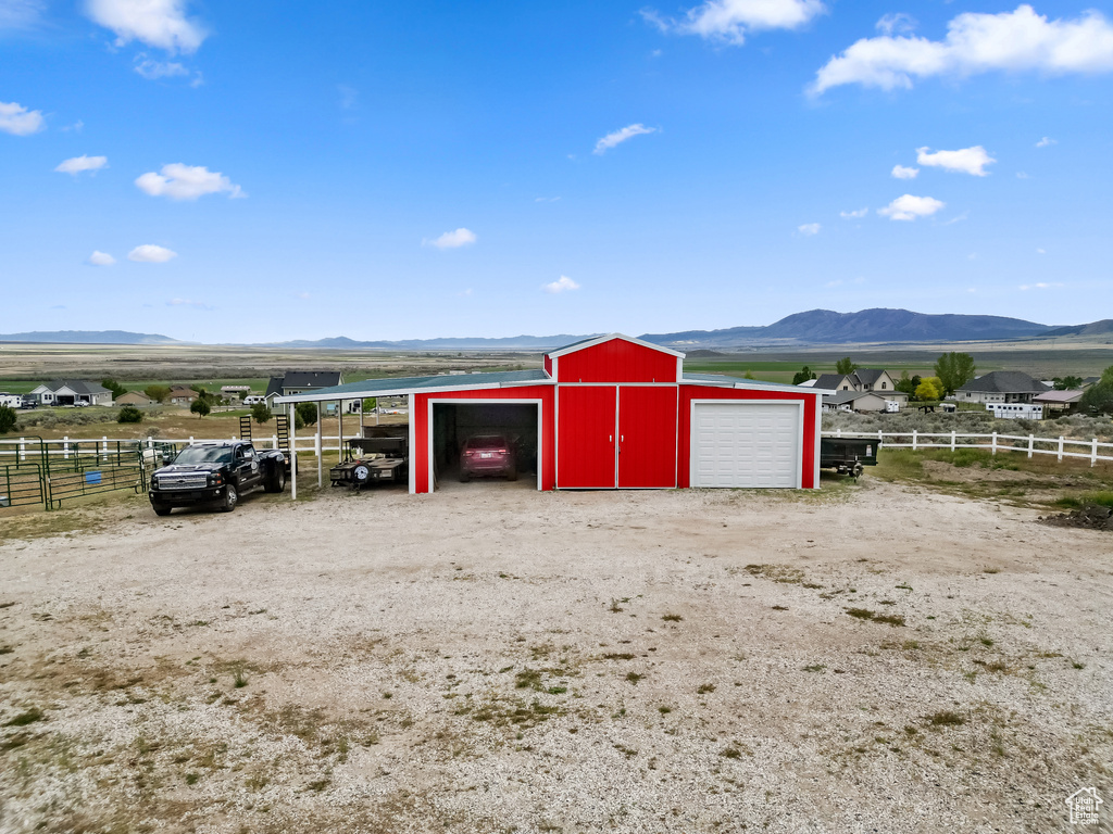 Garage with fence and a mountain view