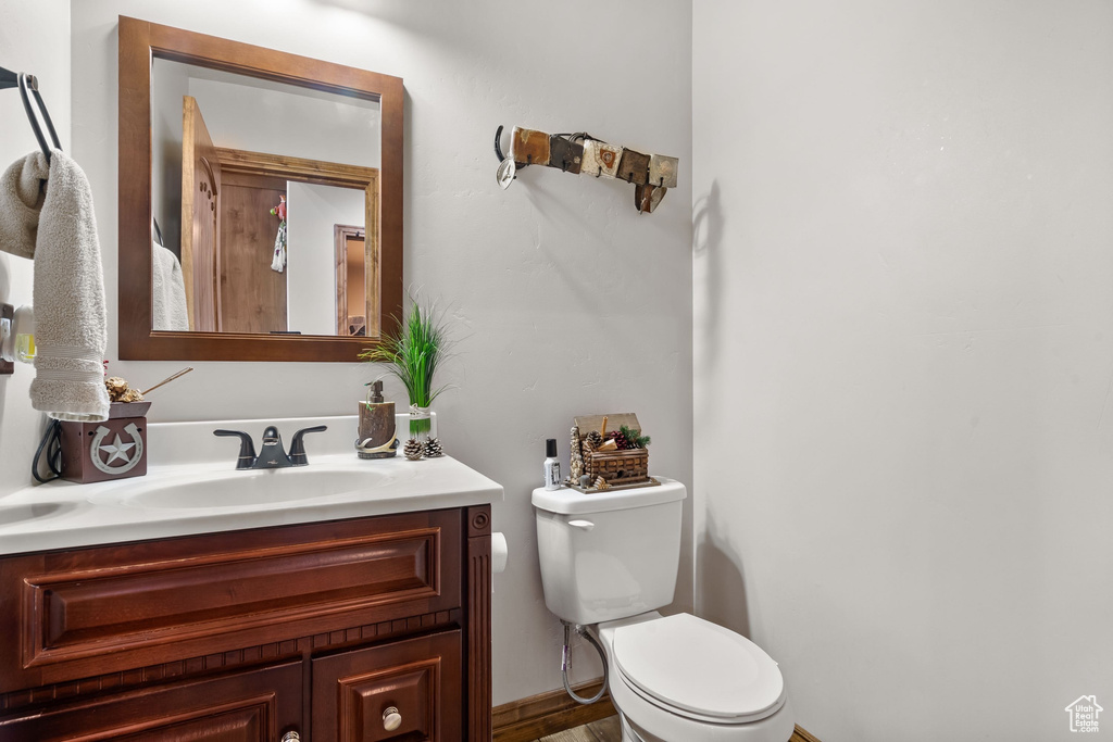 Half bathroom featuring toilet and vanity