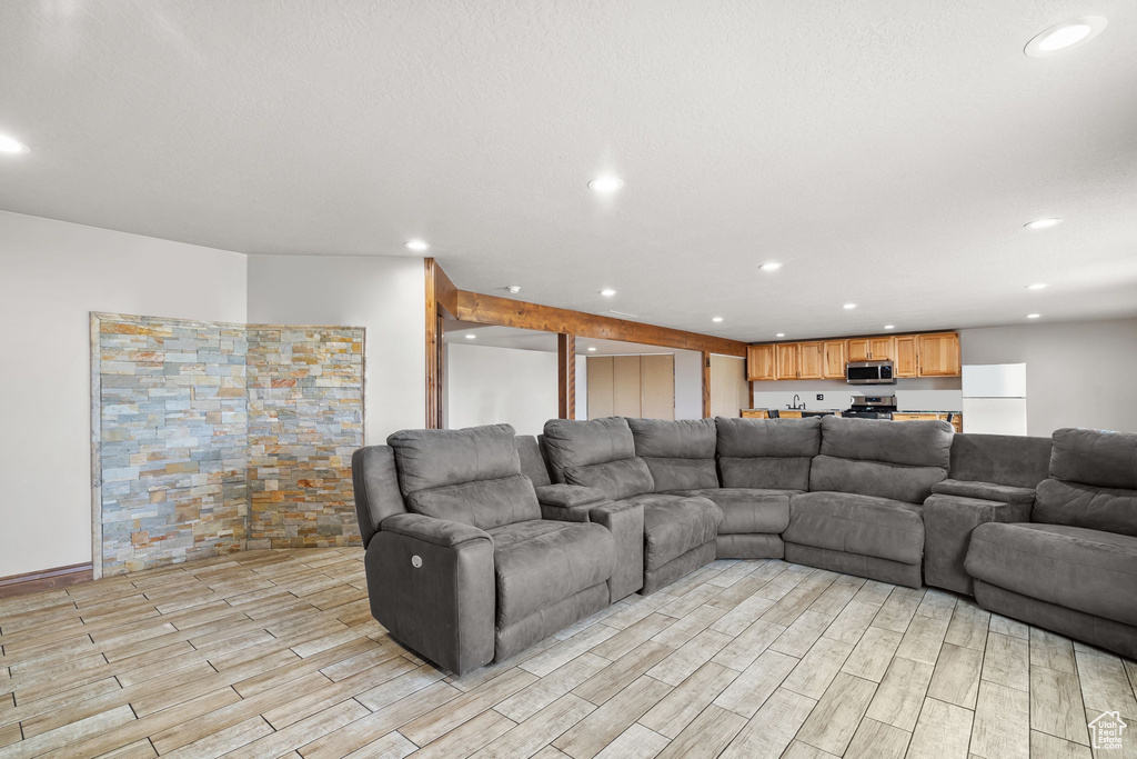 Living room featuring light wood-style floors and recessed lighting