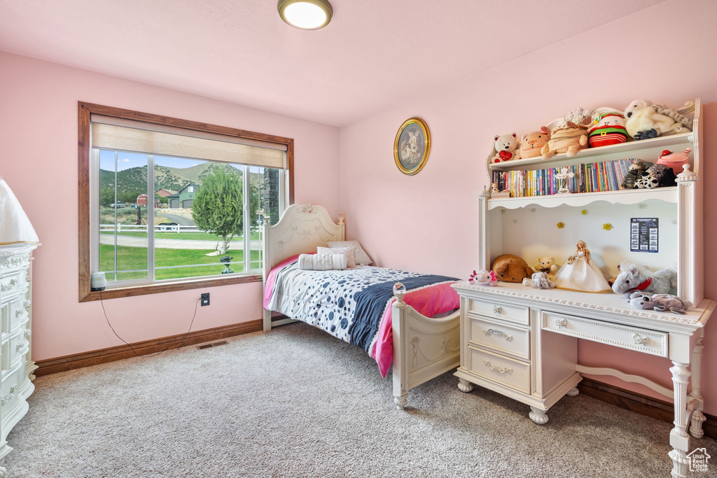 Bedroom featuring light carpet and baseboards