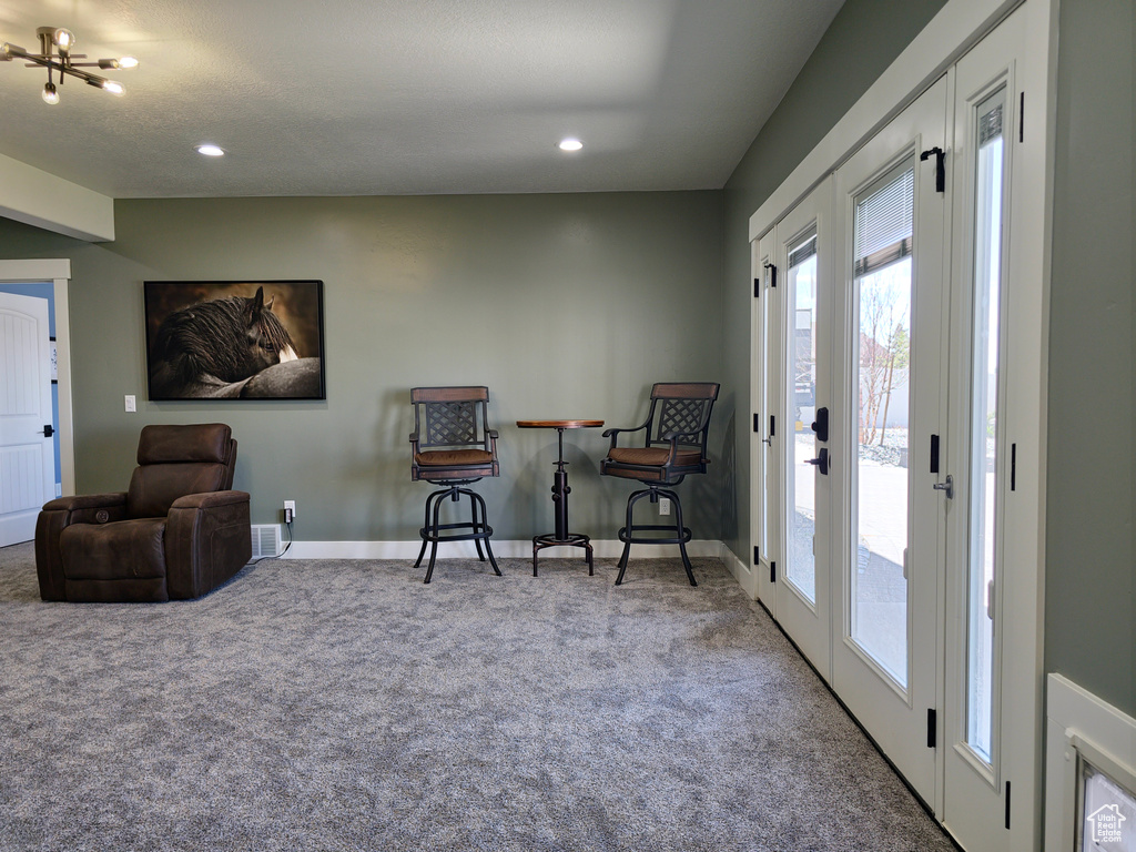 Living area with carpet, baseboards, and recessed lighting