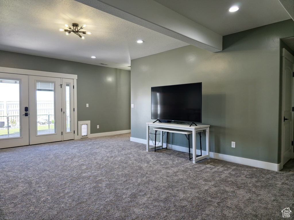 Carpeted living area with baseboards, recessed lighting, and french doors