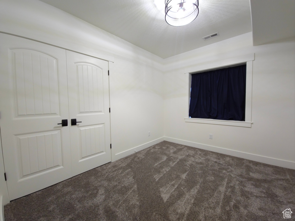 Unfurnished bedroom with carpet, baseboards, and a closet