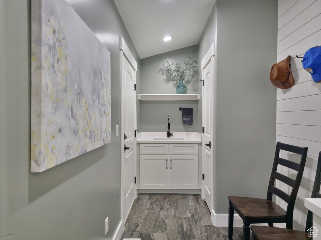 Bar area with a sink and baseboards