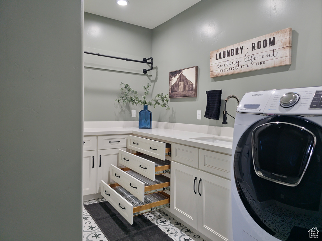Laundry room featuring washer / dryer, cabinet space, and recessed lighting