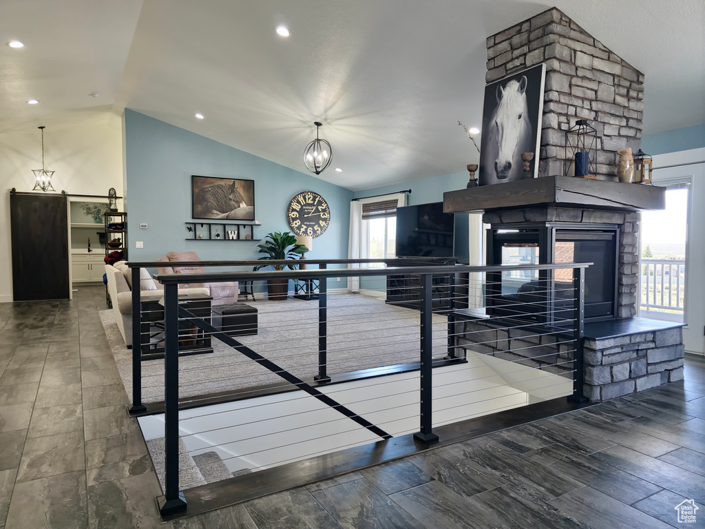 Interior space with vaulted ceiling, a fireplace, recessed lighting, and wood finished floors