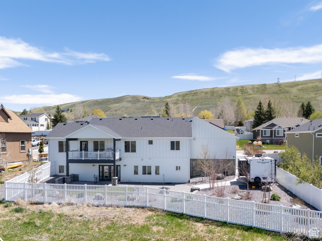 Rear view of property with a residential view, a fenced backyard, a patio area, and a mountain view
