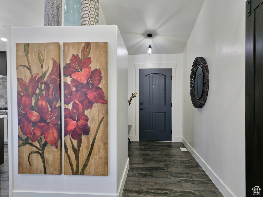 Entrance foyer featuring baseboards and dark wood-style flooring