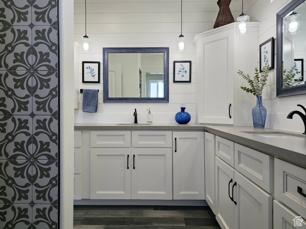 Full bath with vanity and wood finished floors