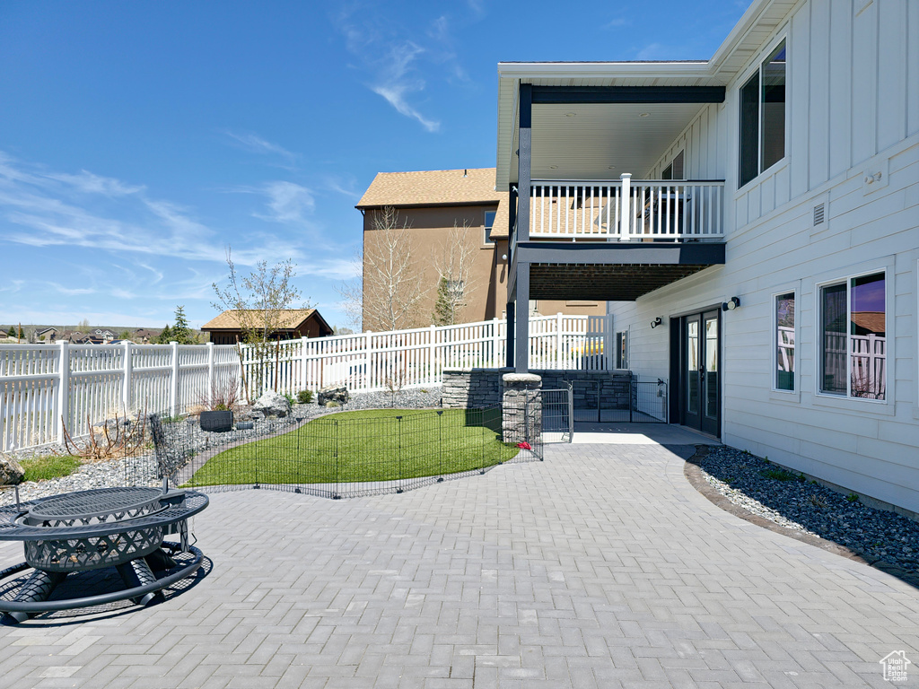 View of patio with a balcony