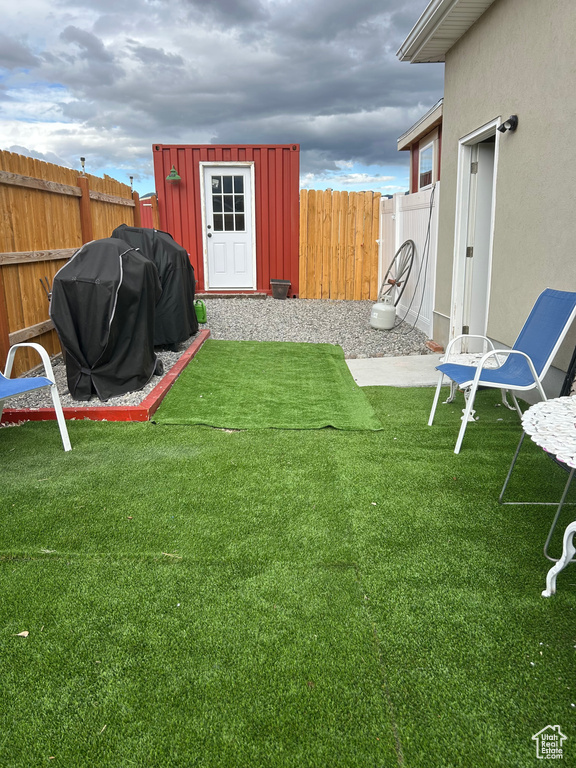 View of yard featuring an outbuilding and a shed
