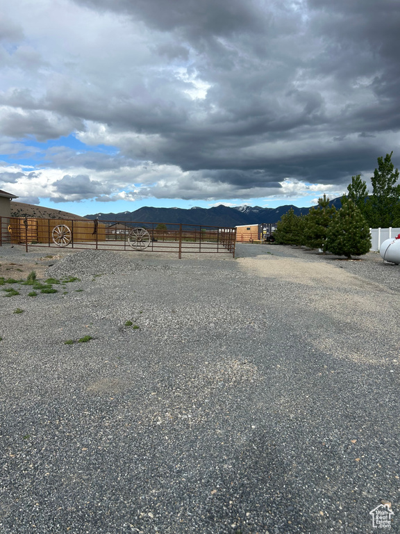 View of yard with fence and a mountain view