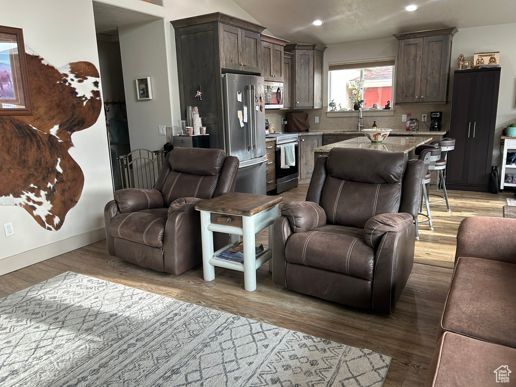 Living room featuring light wood finished floors and recessed lighting