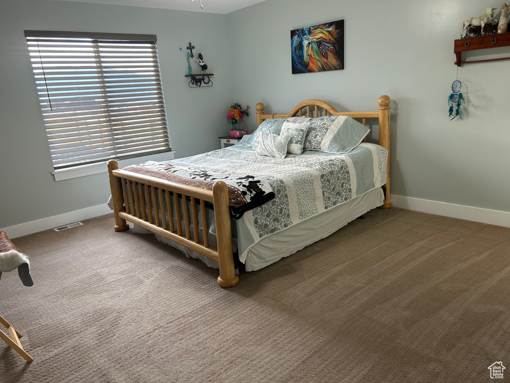 Carpeted bedroom with baseboards