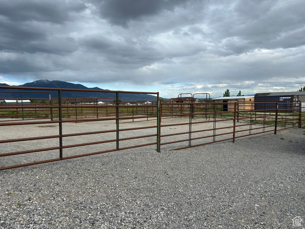 View of yard with an exterior structure, a mountain view, and a rural view
