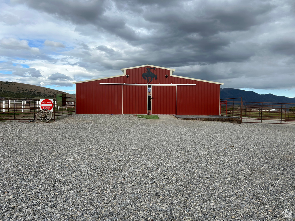 View of pole building featuring fence and a mountain view