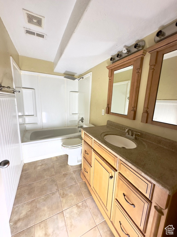 Bathroom with tile patterned flooring, toilet, bathing tub / shower combination, and vanity
