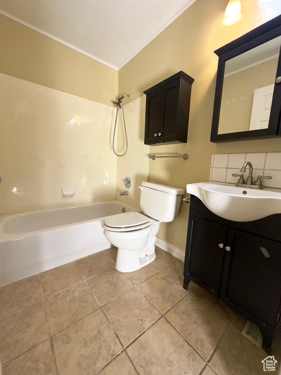 Bathroom featuring crown molding, toilet, tile patterned flooring, vanity, and shower / tub combination
