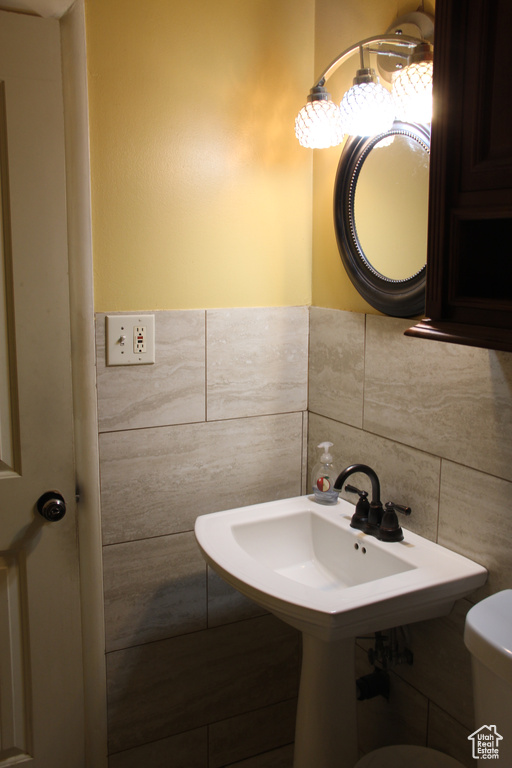 Bathroom with tile walls and toilet
