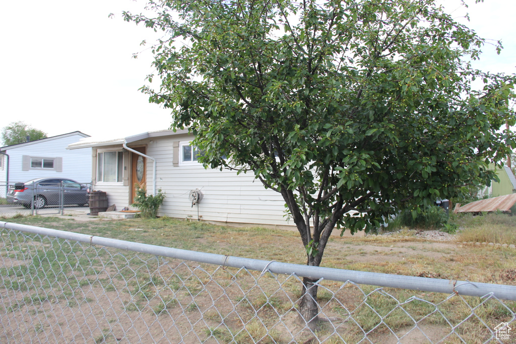 View of front of home featuring fence