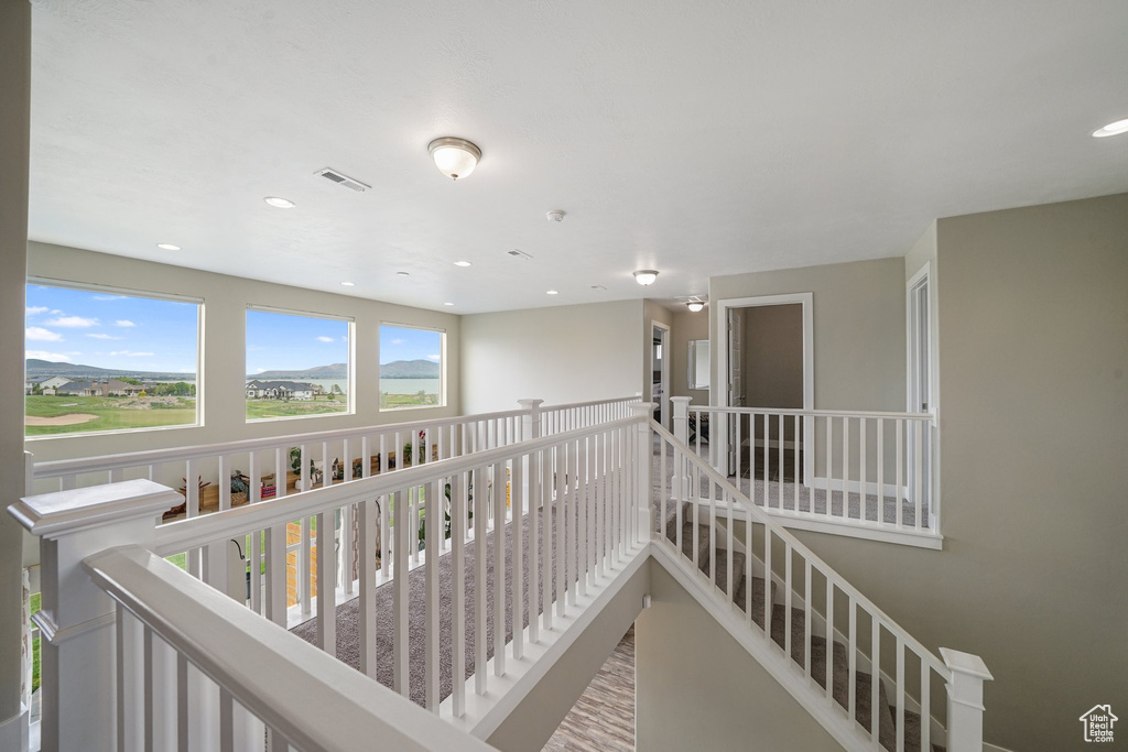 Hall featuring recessed lighting and an upstairs landing