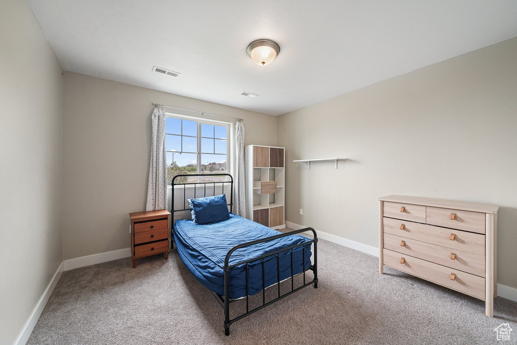 Bedroom featuring carpet flooring and baseboards