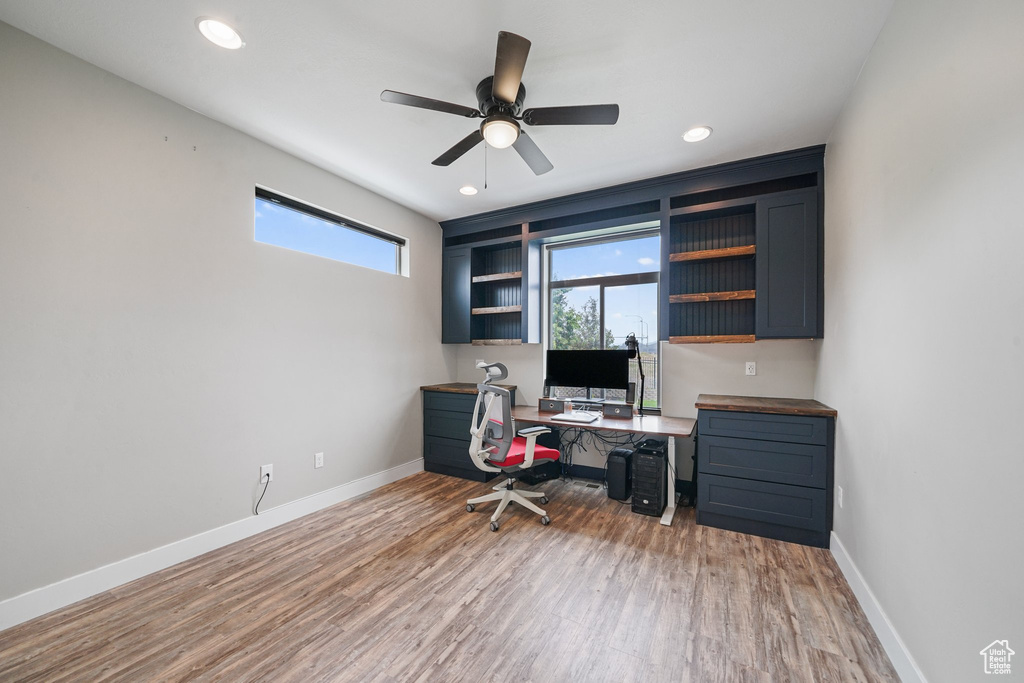 Office space with light wood-style flooring, baseboards, ceiling fan, and recessed lighting