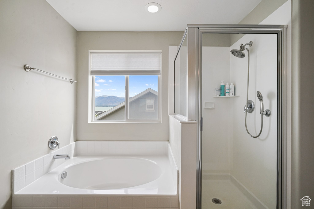 Bathroom featuring a shower stall and a garden tub