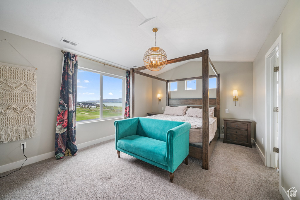 Bedroom with carpet floors, a chandelier, baseboards, and lofted ceiling