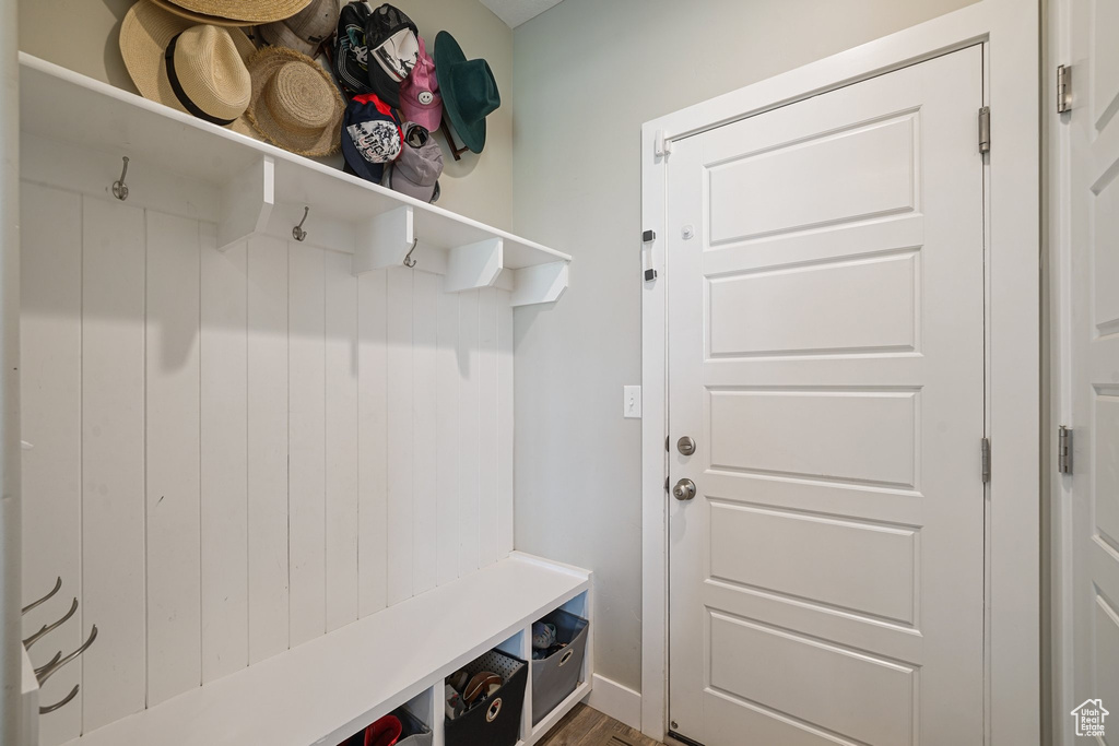 Mudroom with wood finished floors and baseboards