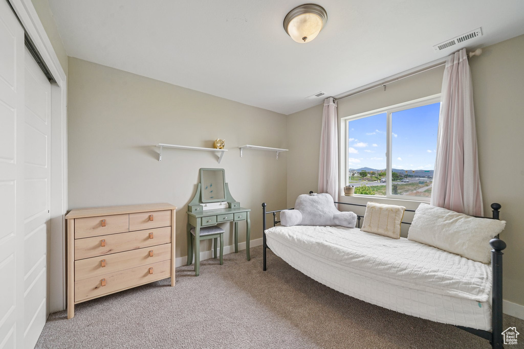 Bedroom featuring light carpet and baseboards