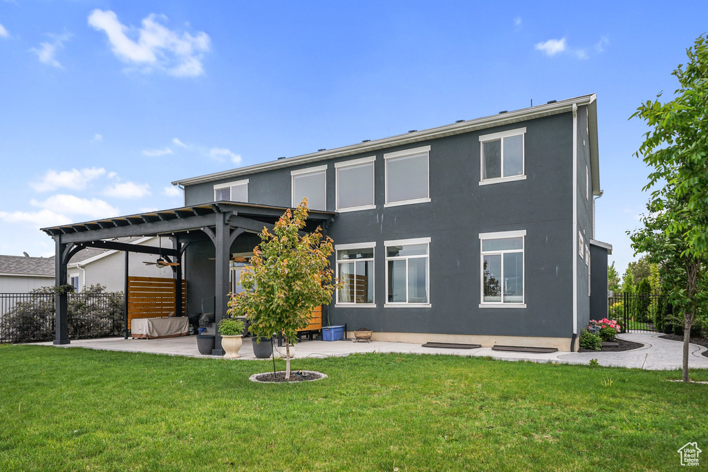 Back of property featuring ceiling fan, a patio area, and stucco siding