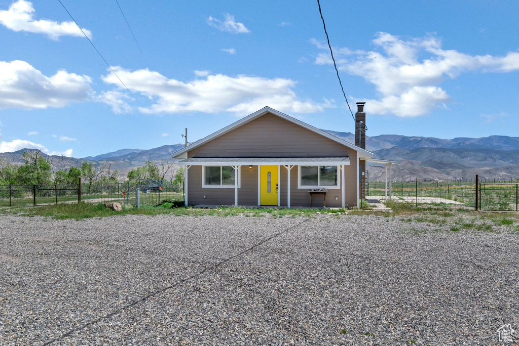 Bungalow-style house with a mountain view, fence, and a porch