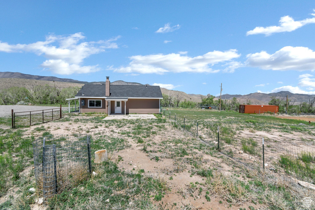 Rear view of property featuring a mountain view and a rural view