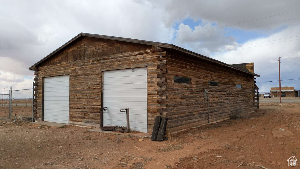 View of outbuilding featuring an outbuilding and fence