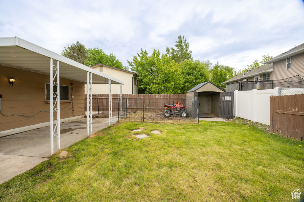 View of yard with a storage unit and an outdoor structure
