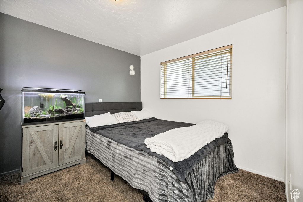 Carpeted bedroom featuring baseboards