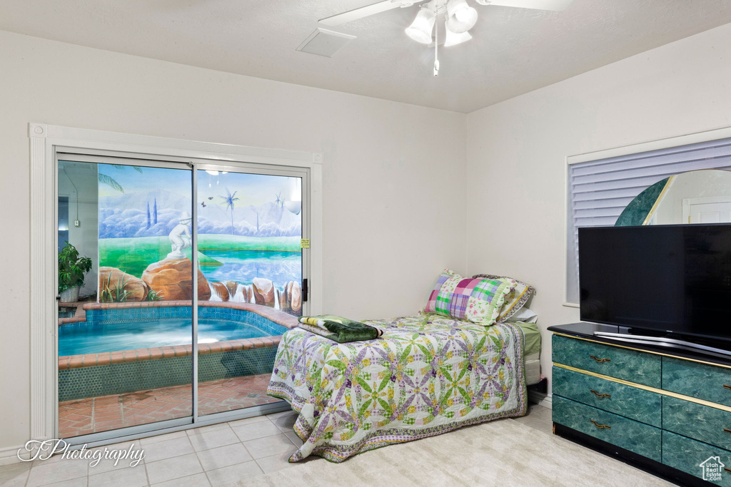 Tiled bedroom featuring access to outside and ceiling fan