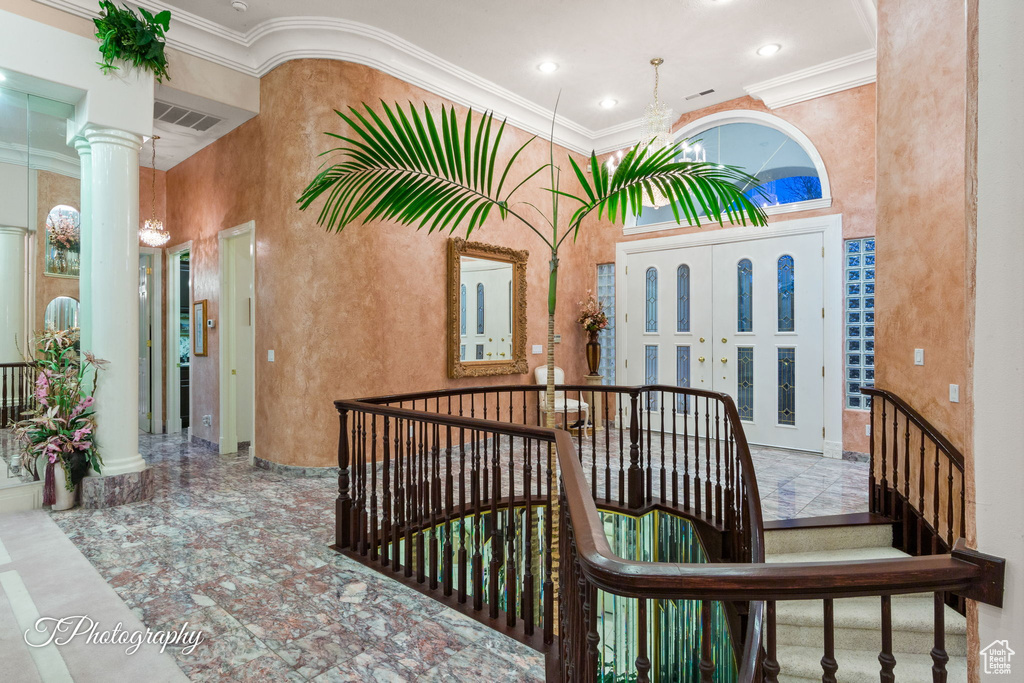 View of exterior entry featuring stucco siding and covered porch