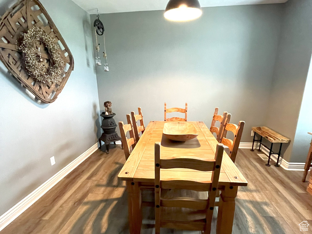 Dining area featuring wood finished floors and baseboards