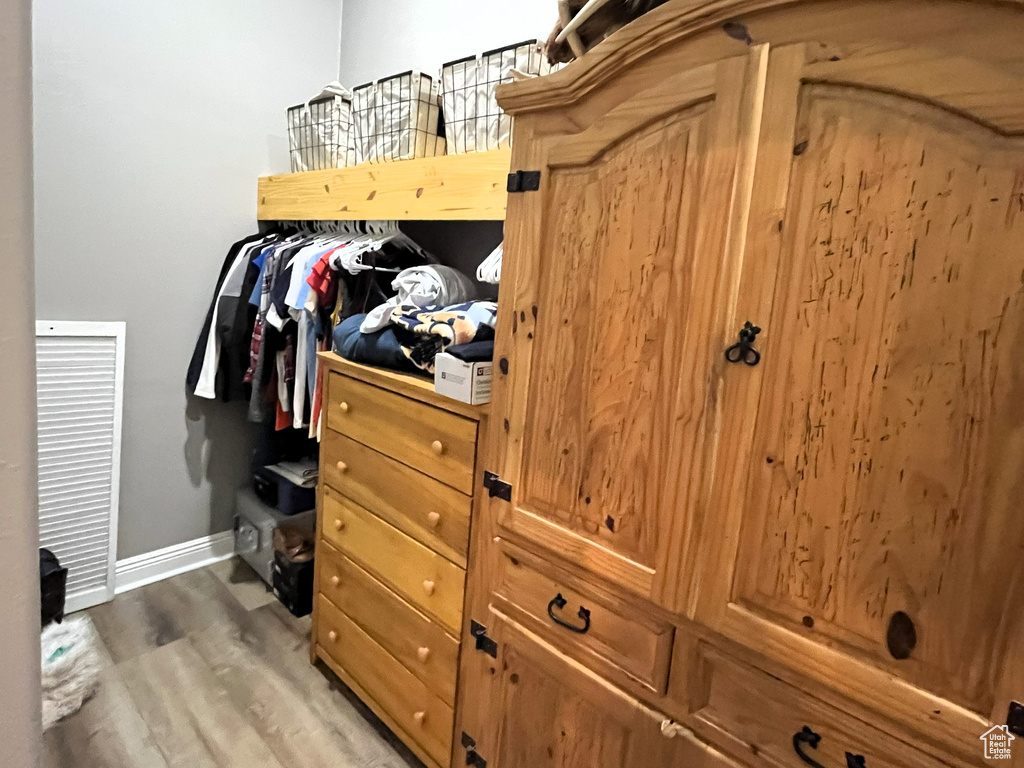 Walk in closet featuring light wood-style floors