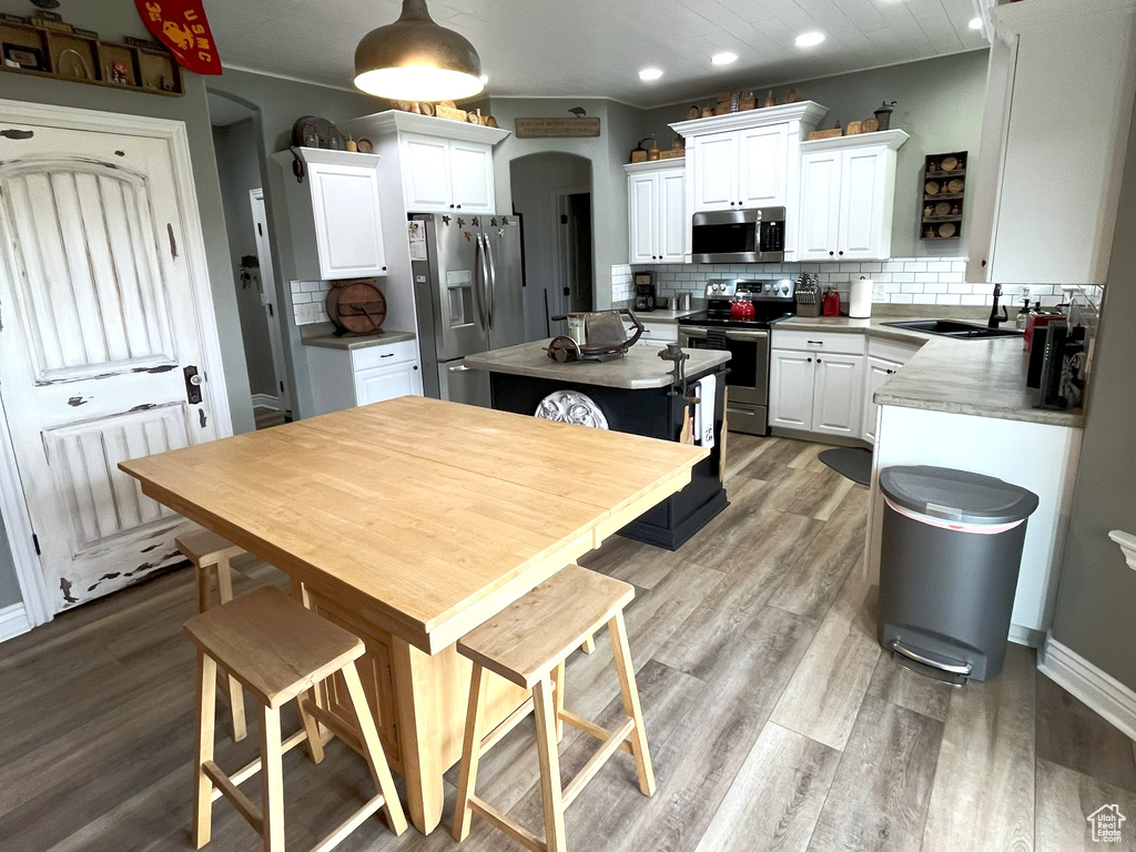 Dining area featuring light wood finished floors and recessed lighting